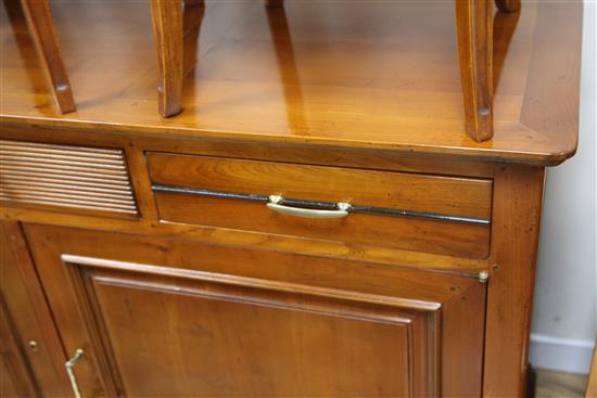 A 20th century French cherrywood radially extending dining table, the circular table extends to 6ft 7in.